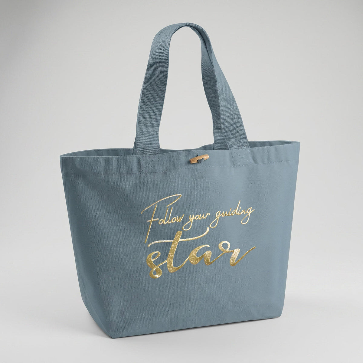 Hellblaue XL Bio Tote bag aus robustem Canvas und 100% Biobaumwolle mit großer metallisch schimmernder Logostickerei, Schriftzug Follow your guidng star. Ein Modell der spirituellen Modemarke Leitstern.